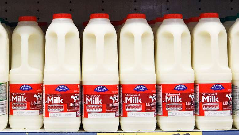 Bottles of fresh skimmed, semi-skimmed and full cream milk for sale on supermarket shelves in the United Kingdom