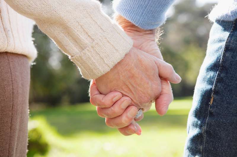 senior couple holding hands