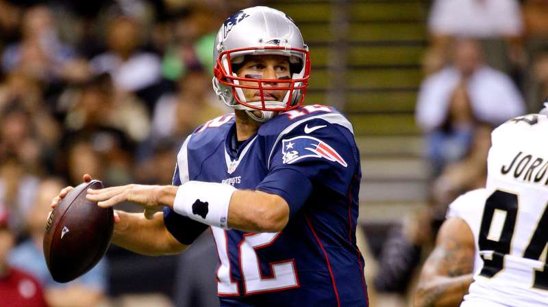 New England Patriots quarterback Tom Brady (12) throws against the New Orleans Saints during the first quarter of a preseason game at the Mercedes-Benz Superdome.