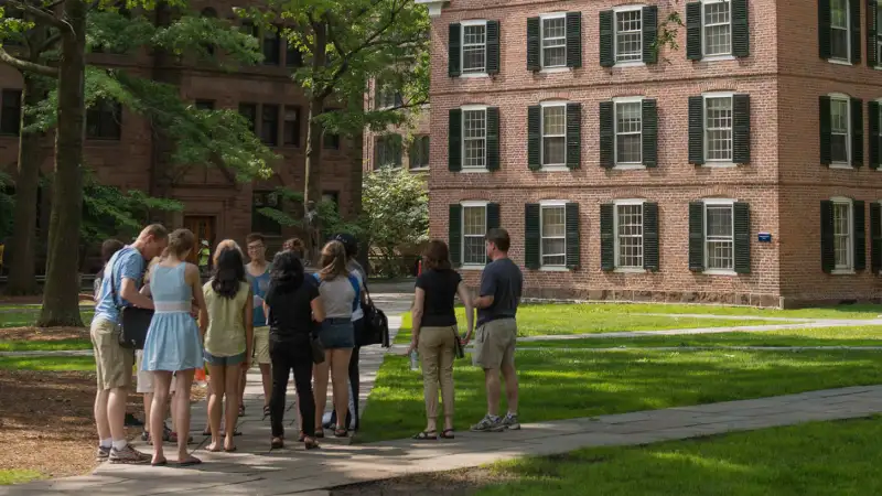 A tour group makes a stop at Connecticut Hall on the Yale University campus in New Haven, Connecticut, U.S., on June 12, 2015.