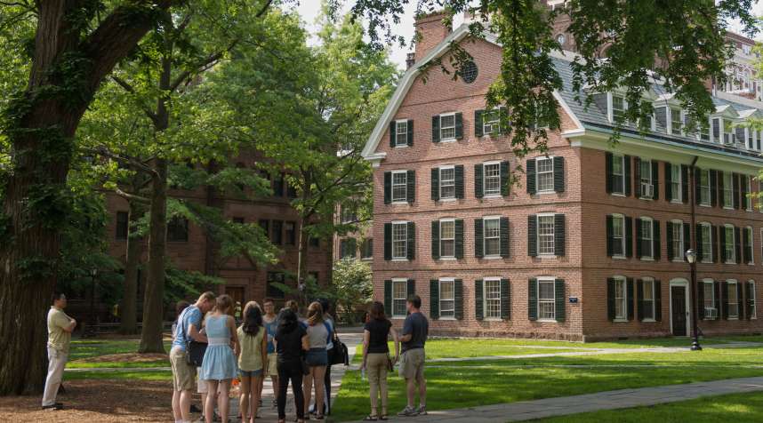 A tour group makes a stop at Connecticut Hall on the Yale campus in New Haven, Conn.