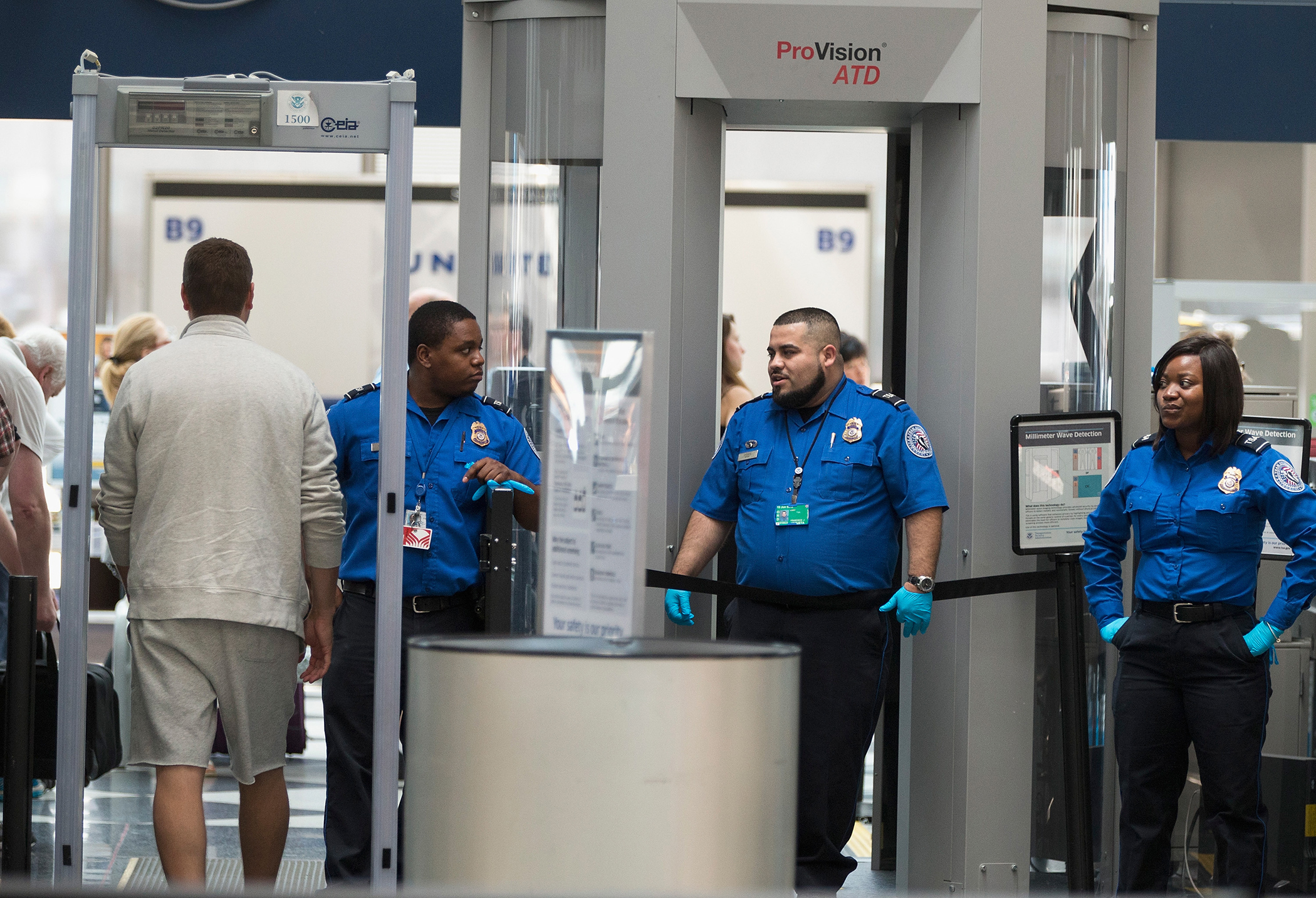 Travelers are screened by Transportation Security Administration workers at a security check point at O'Hare Airport on June 2, 2015 in Chicago, Illinois.