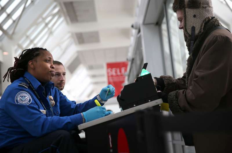 A TSA agent checks a traveler's identification at a special TSA Pre-check lane at Terminal C of the LaGuardia Airport on January 27, 2014 in New York City.