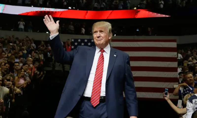 Republican presidential candidate Donald Trump waves to supporters as he takes the stage for a campaign event in Dallas, Monday, Sept. 14, 2015.