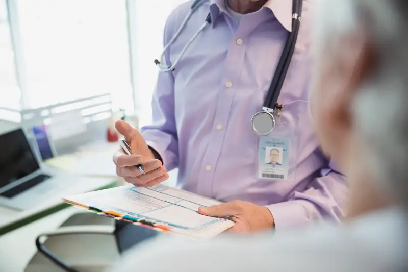 Doctor reviewing medical chart with patient