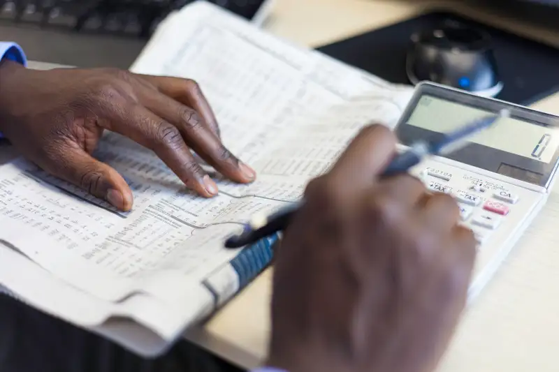 African businessman busy with his calculations.