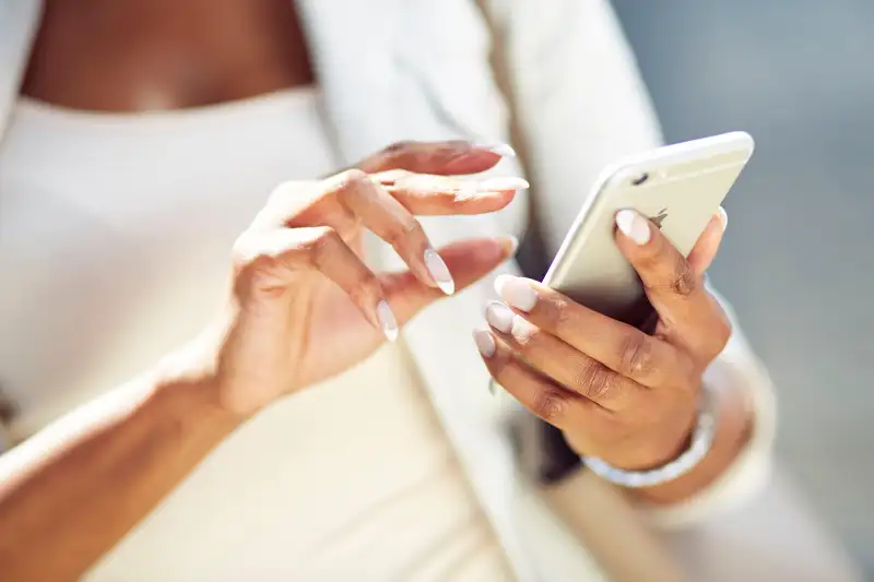 fashionable woman using iPhone