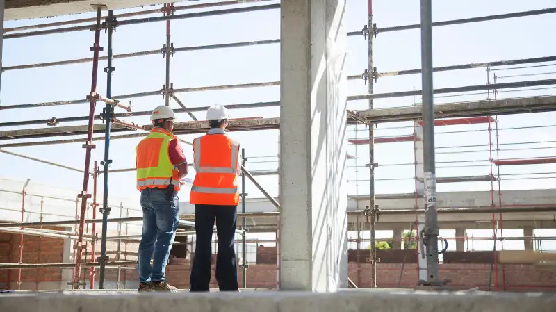 Builder and architect on construction site