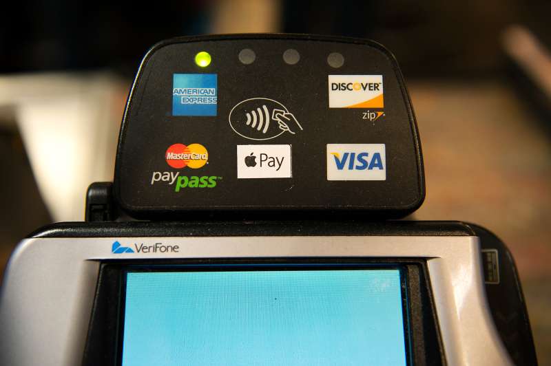 Apple Pay is promoted on signs placed at the cash register of Whole Foods in Columbus Circle on October 20, 2014 in New York, NY.