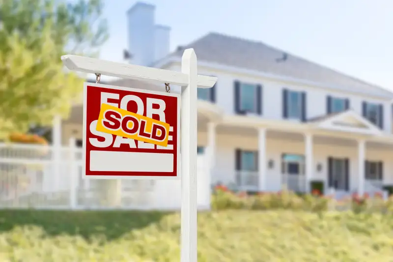 SOLD  sign in front of house