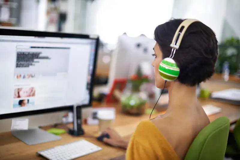 woman wearing headphones in office