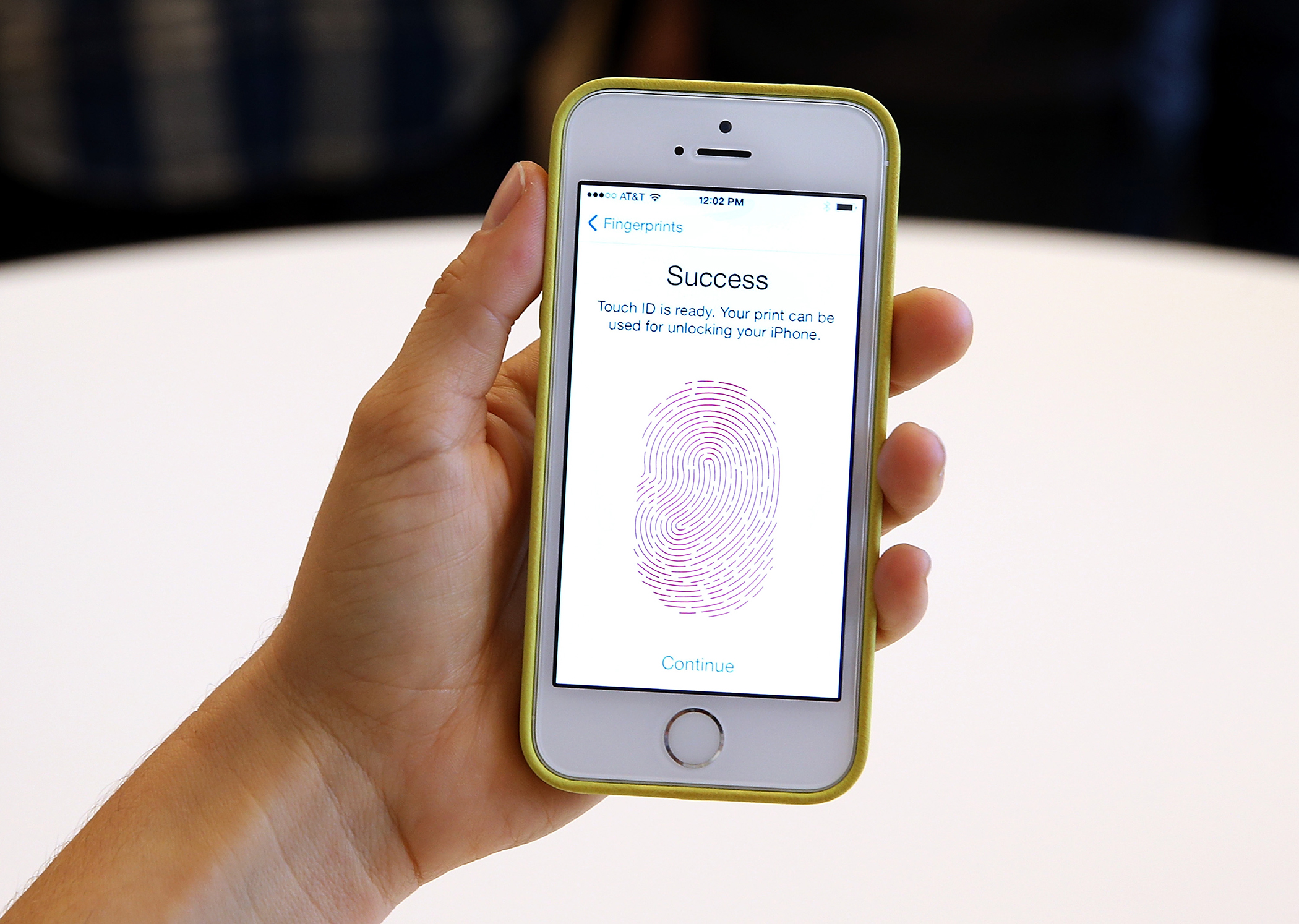 The new iPhone 5S with fingerprint technology is displayed during an Apple product announcement at the Apple campus on September 10, 2013 in Cupertino, California. The company launched the new iPhone 5C model that will run iOS 7 is made from hard-coated polycarbonate and comes in various colors and the iPhone 5S that features fingerprint recognition security.
