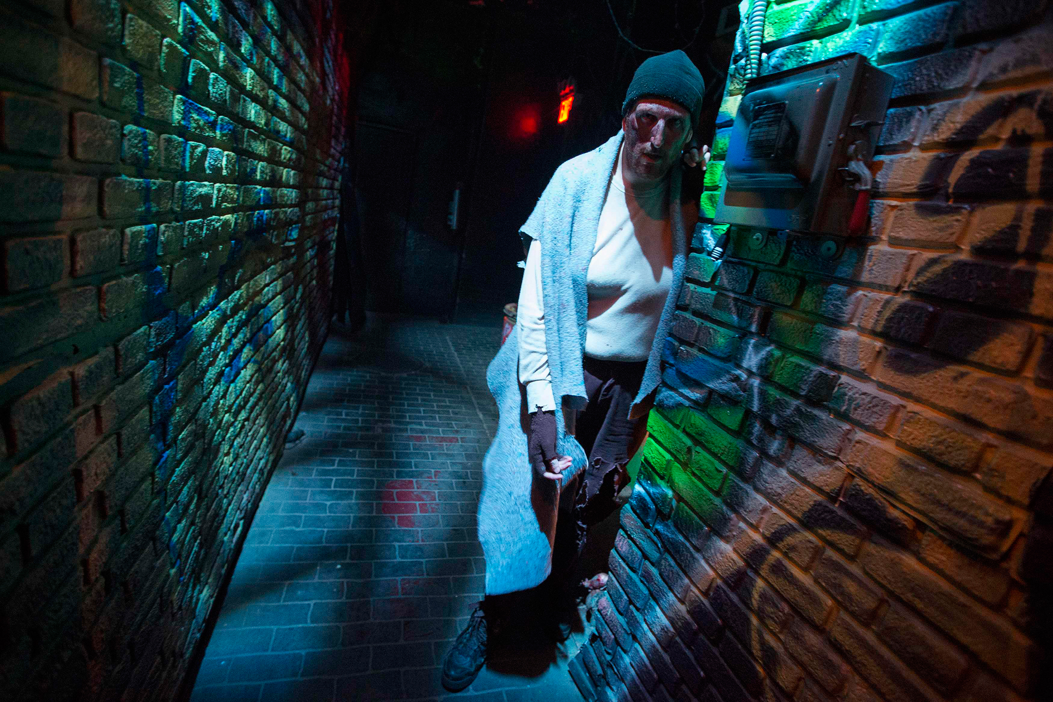 An actor depicting a deranged homeless man living with rats in a New York City alley is seen inside Nightmare: New York, a haunted house for adults, in New York October 22, 2014.