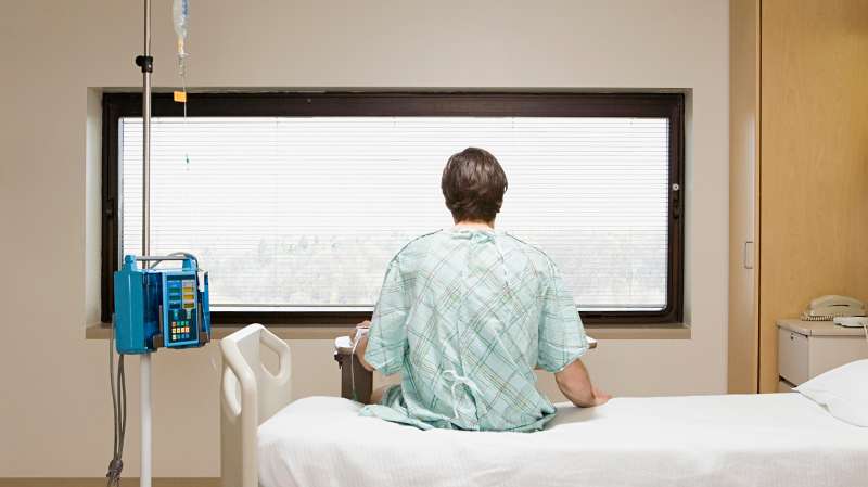 patient sitting on hospital bed
