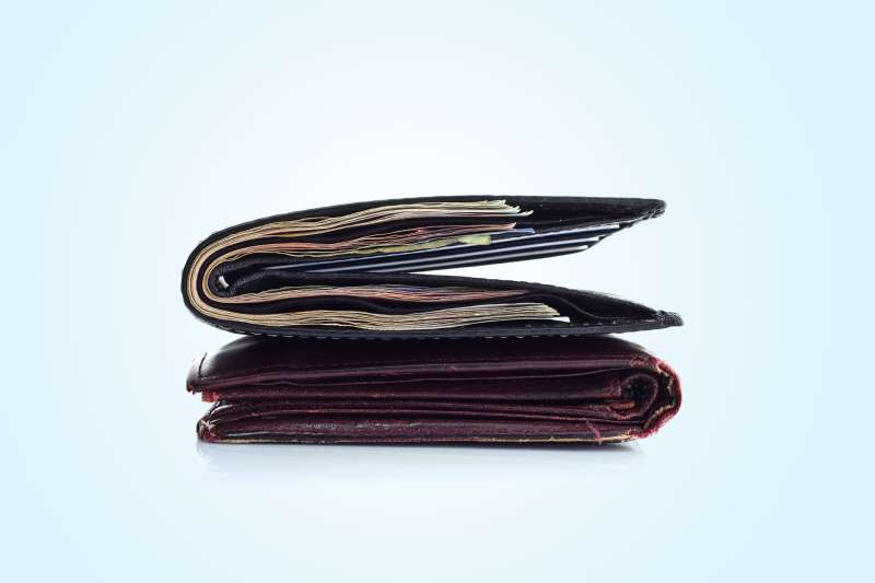 filled wallet on top of empty wallet