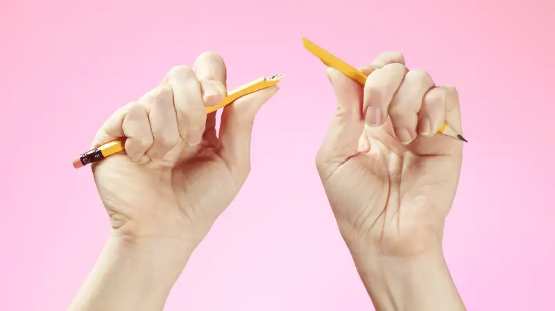 hands breaking pencil