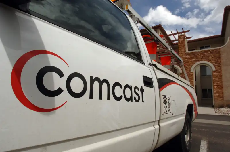 The Comcast logo is pictured on the side of a truck sitting