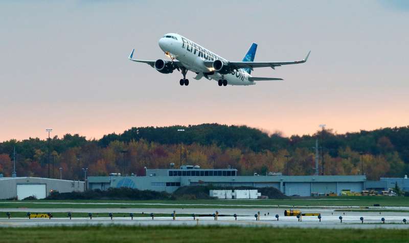 A Frontier Airlines plane flies out of Cleveland Hopkins International Airport, October 15, 2014, in Cleveland.