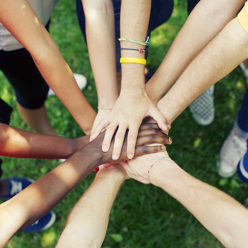 a team putting hands in circle to show unity