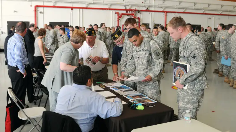 U.S. Army Reserve Soldiers attending the Operation Sustainment Warrior 2014 event on Joint Base McGuire-Dix-Lakehurst gather at the UPS table alongside members of the New Jersey American Legion during the , Hiring Our Heroes,  job fair. Co-sponsored by the U.S. Chamber of Commerce Foundation and 377th Theater Support Command, this event featured dozens of local employers seeking veterans and eligible military spouses to fill their positions. The job fair also offered resume workshops and financial counseling for attendees.