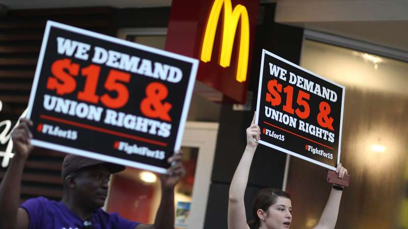 Cecelia O'Brien (R) joins other workers to protest outside a McDonald's restaurant on November 10, 2015 in Miami, Florida. The protesters are demanding action from state legislators and presidential candidates to raise the minimum wage to $15 an hour.