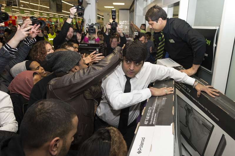 Customers buying large television sets during Black Friday Sales at Asda Wembley Superstore, London, Britain, November 28, 2014.