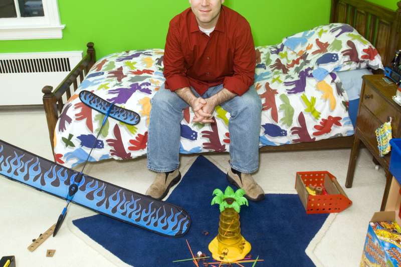millennial man in childhood bedroom