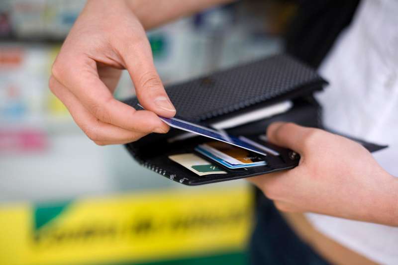 man pulling credit card from wallet