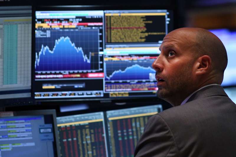A trader works on the floor of the New York Stock Exchange (NYSE) on August 24, 2015 in New York City. The Dow Jones industrial average briefly dropped over 1000 points in morning trading and closed down 588 points.