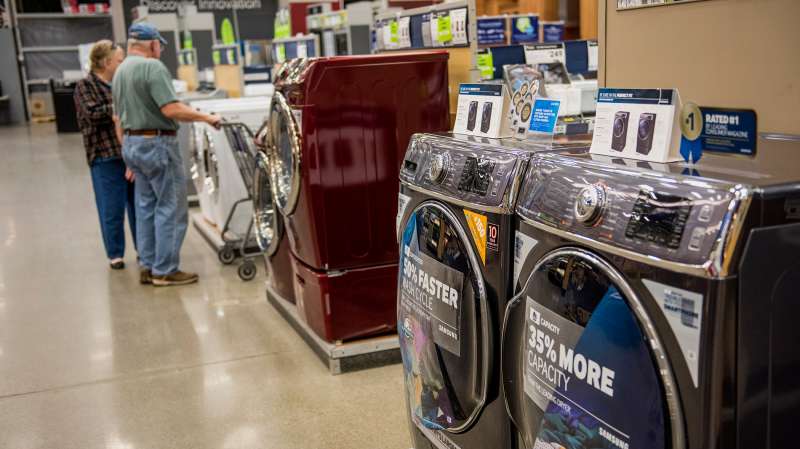 Customers browse washing machines on sale at a Lowe's Cos. store in San Bruno, California, on February 20, 2015.