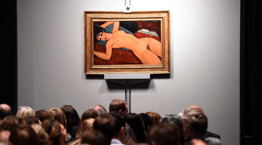 Crowds sit in front of Amedeo Modigliani's  Nu couche  during the  Artist Muse: A Curated Evening Sale” on November 9, 2015 at Christie's New York.  The painting sold for $170,405,000.