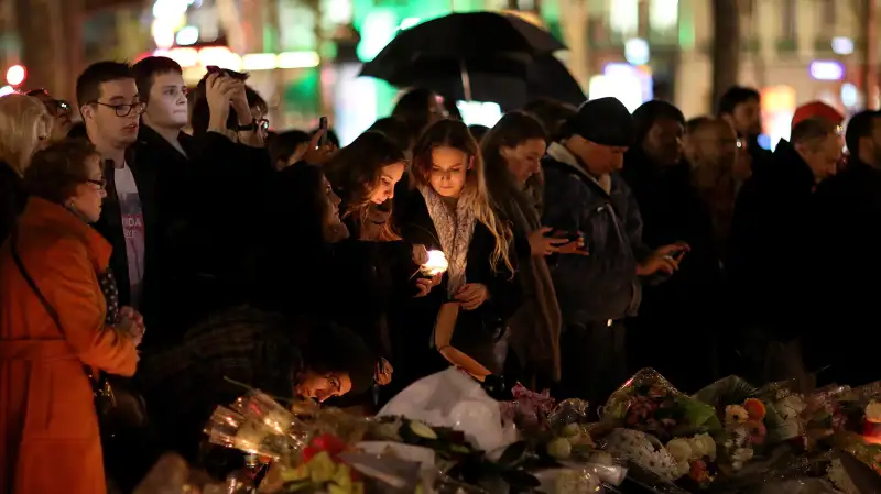 People light candles at a makeshift memorial at the place de la republique on November 17, 2015 in Paris, France. Paris remains under heightened security following terrorist attacks , which left at least 129 people dead and hundreds more injured.