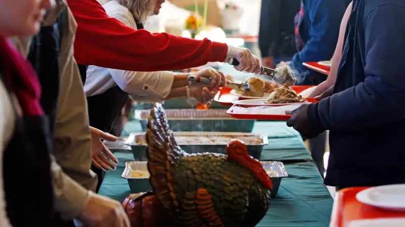 Volunteers help serve Thanksgiving meals during the 22nd annual Thanksgiving Day dinner hosted by St. Peter's Catholic Church and First Baptist Church of Columbia in Columbia, South Carolina, November 22, 2012.