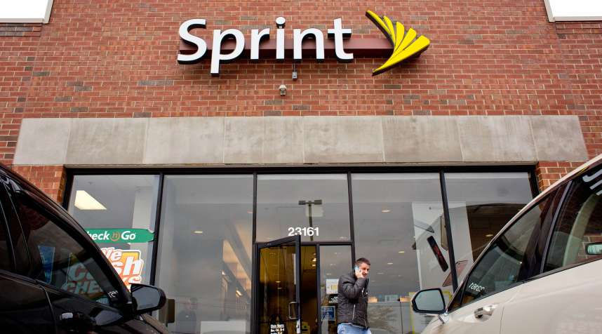 A customer talks on a cell phone while exiting a Sprint store in Woodhaven, Michigan, on October 29, 2015.