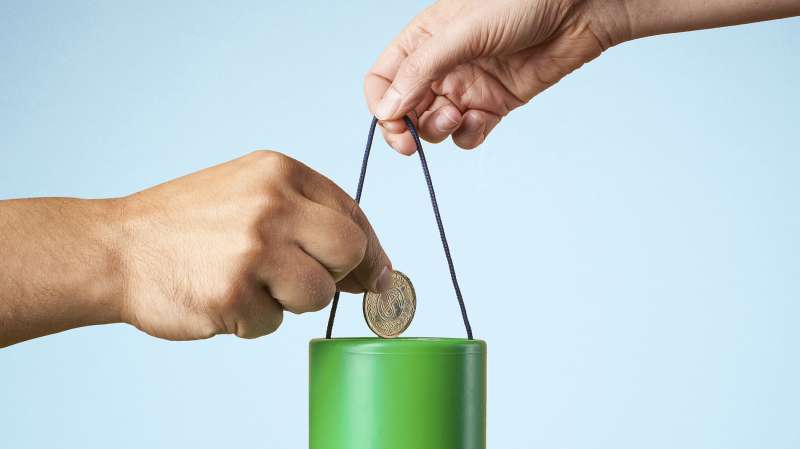 putting money in charity container