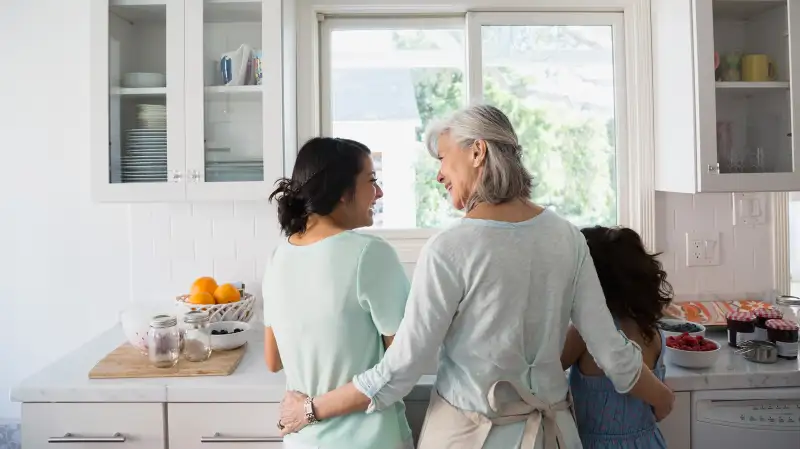 grandmother at sink with grandkids