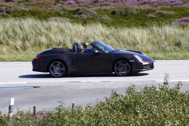 couple in a porsche