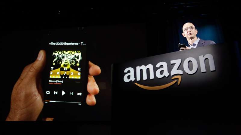 Amazon CEO Jeff Bezos shows off his company's new Fire smartphone at a news conference in Seattle, Washington June 18, 2014.