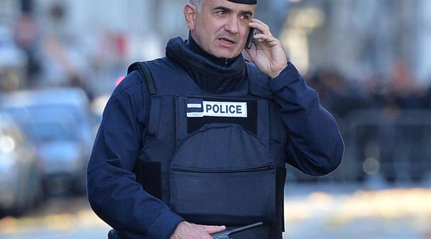 French police officer is seen as having a phone conversation in front of Notre Dame in Paris following the terrorist attack.