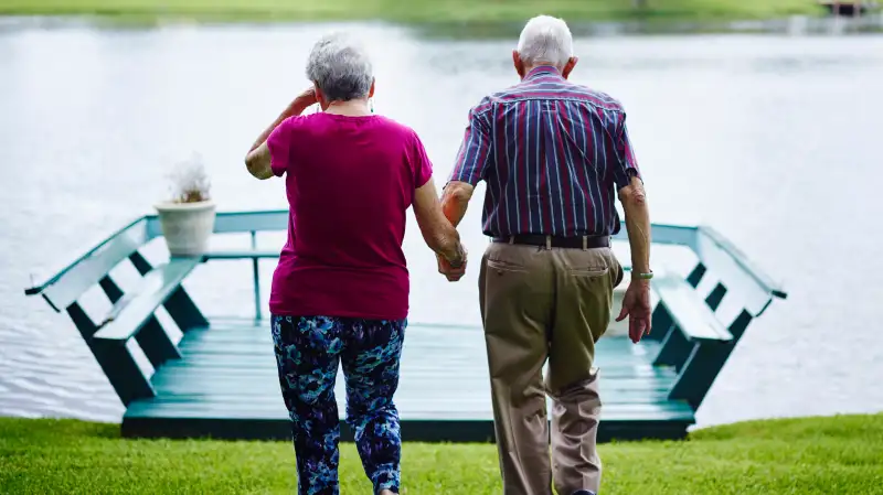 Dick Pell looks after his wife, Helen, at their Sarasota home.