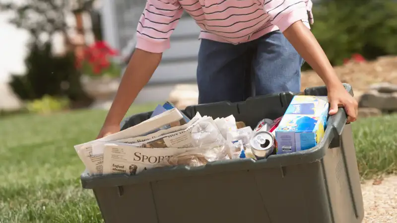 kid taking out recycling