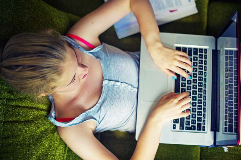 Teenage girl using laptop