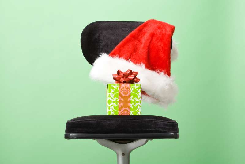 holiday gift in chair with santa hat