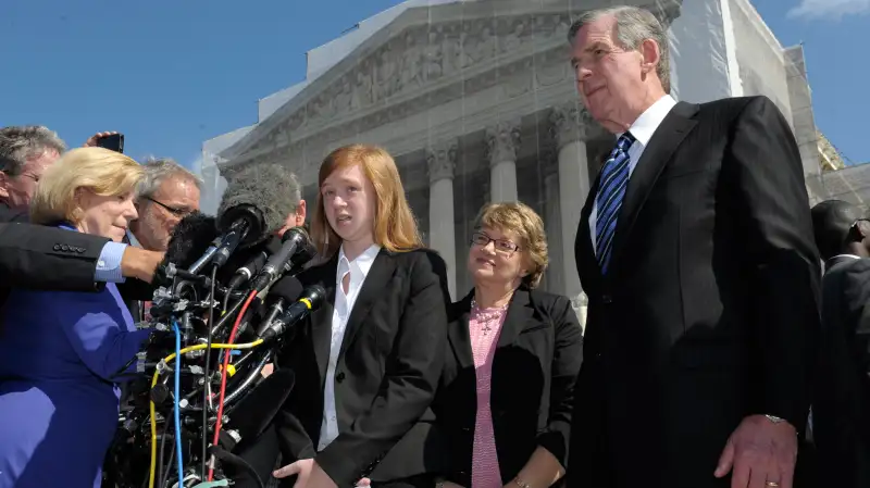 Abigail Fisher, the Texan involved in the University of Texas affirmative action case, accompanied by her attorney Bert Rein, right, talks to reporters outside the Supreme Court in Washington, October 10, 2012.