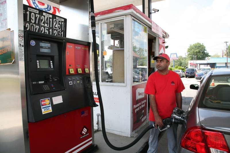 A gas attendant at a 19 Petroleum gas station pumps gas on August 25, 2015 in Woodbridge, New Jersey.