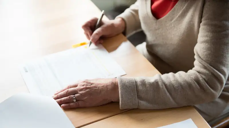 senior filling out paperwork