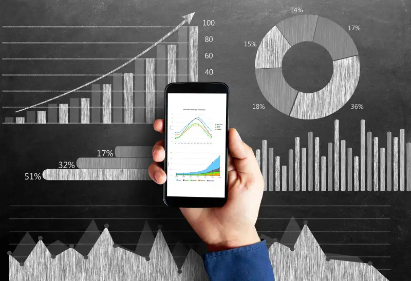 hand with stock figures on smartphone