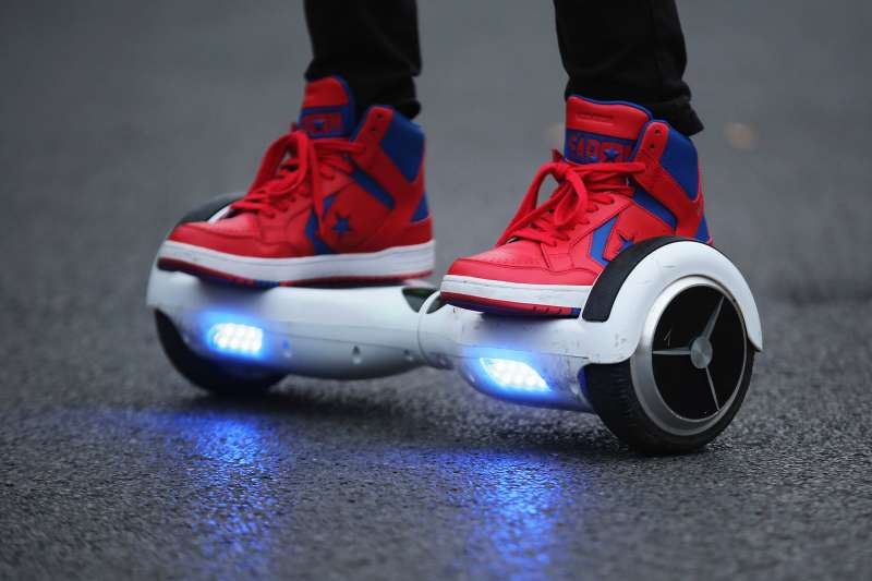 A youth poses as he rides a hoverboard, which are also known as self-balancing scooters and balance boards.