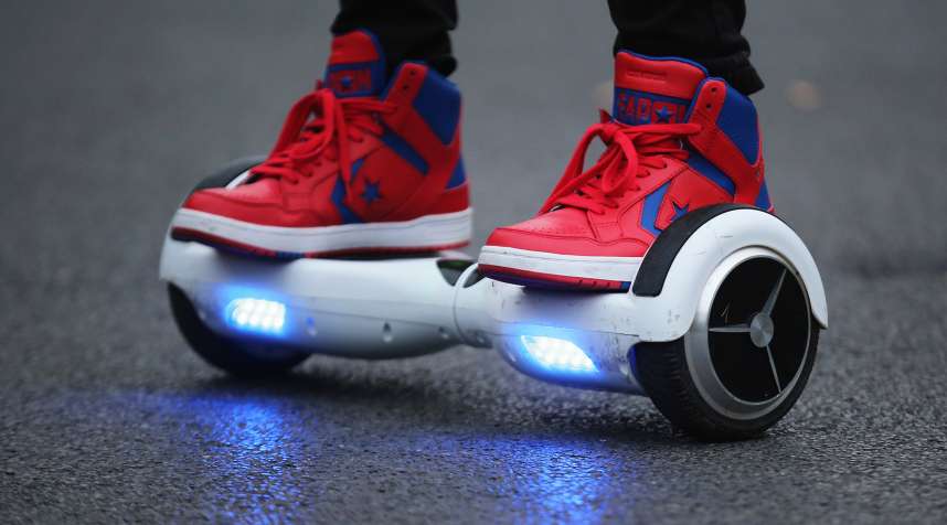 A youth poses as he rides a hoverboard, which are also known as self-balancing scooters and balance boards.