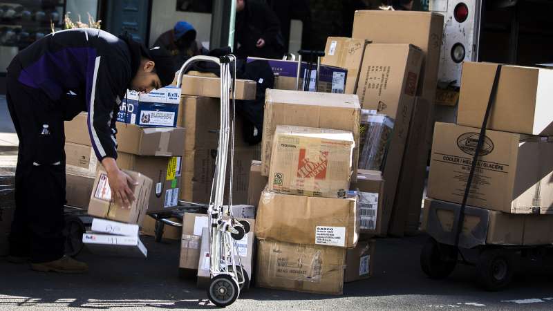 A FedEx employee sorts packages for delivery in Midtown New York, on December 4, 2015.